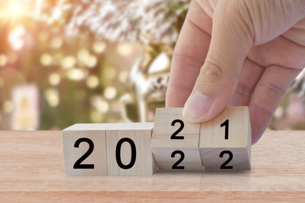 New year 2020 change to 2021. Hand flip over wooden cube block. New year holiday concept